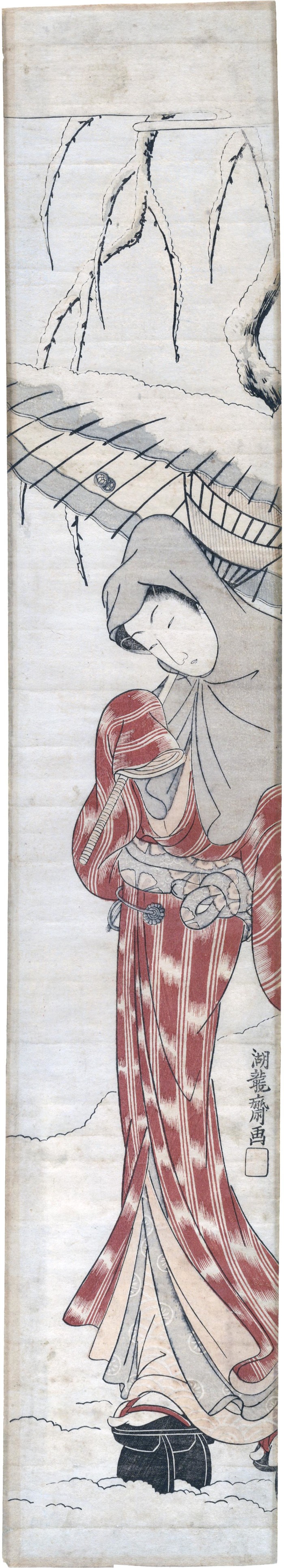 Young woman under willow in the falling snow