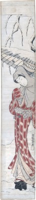 Young woman under willow in the falling snow