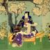 Triptych of Mitsuuji with two <i>bijin</i> near cherry blossoms - a Rustic Genji theme - possible titile: <i>Hanasakari</i> or 'Cherry blossoms at their best at Ueno' (花さか里)